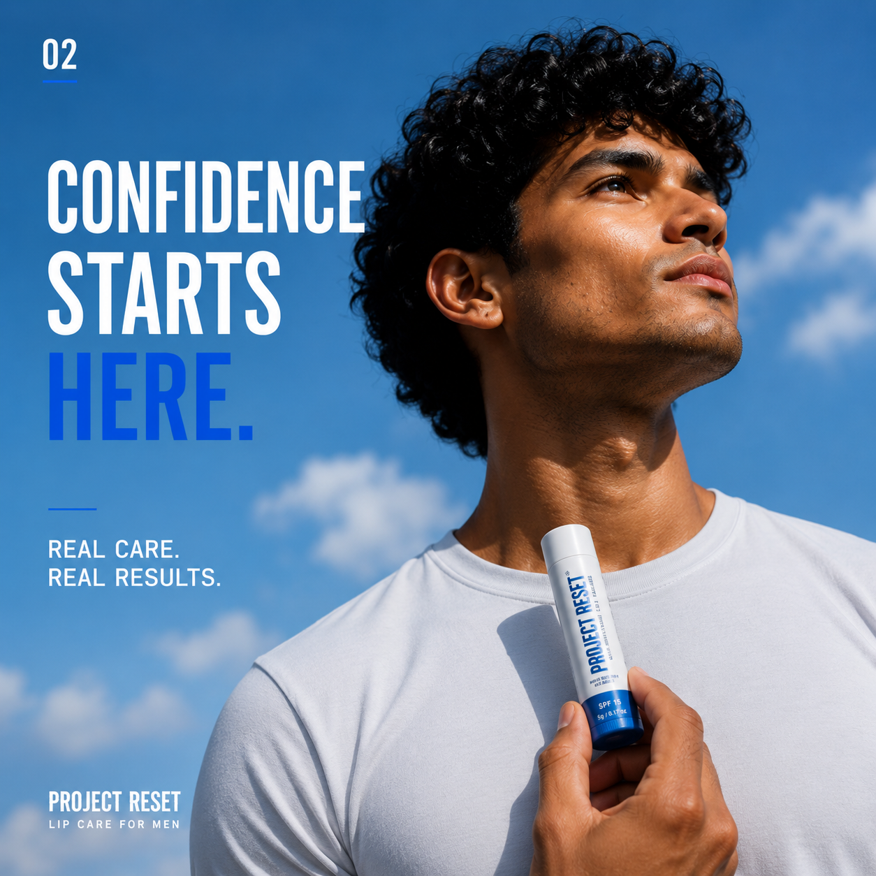 Man against a blue sky holding a Project Reset lip balm